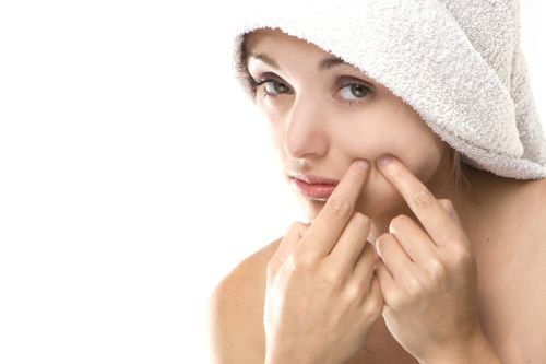 Pimple , spot on beauty woman face with a white towel